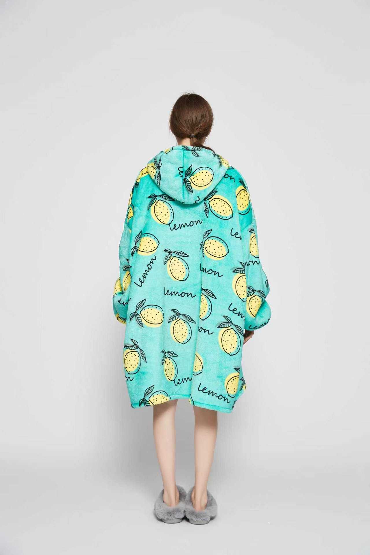 Back view of the Lemon Squeeze wearable blanket with the hood up showing the all-over lemon print