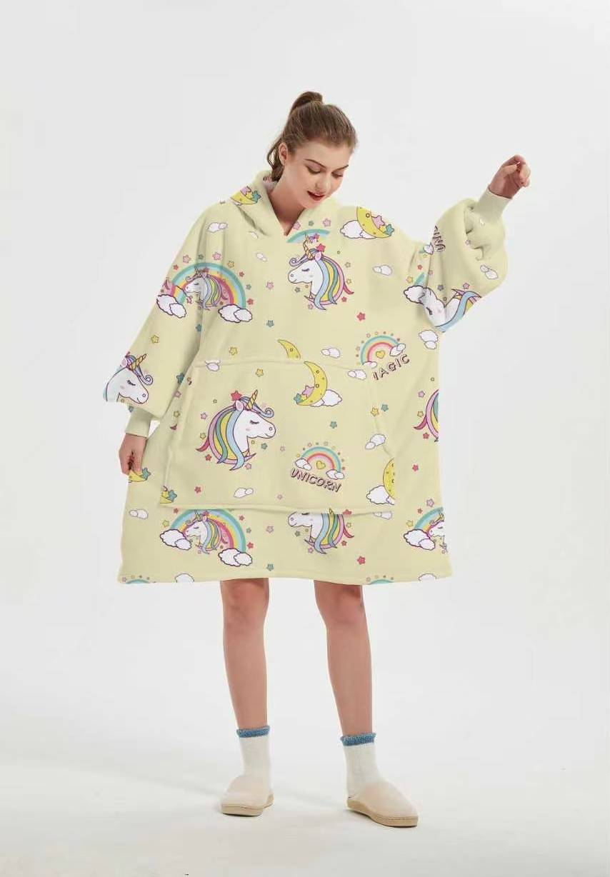 Front view of the Unicorn Dream wearable blanket showing the hood, ribbed cuffs and large front pocket
