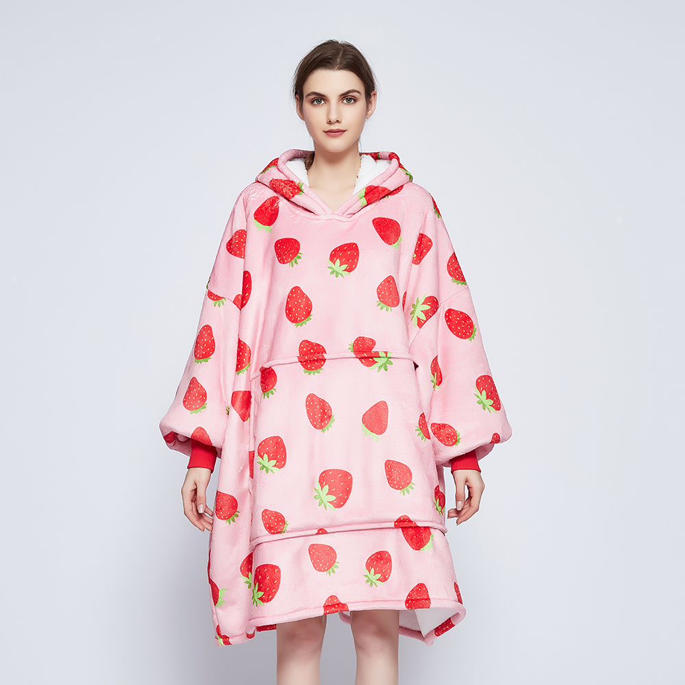 Front view of the Strawberry Crush wearable blanket showing the hood, red ribbed cuffs and giant front pocket